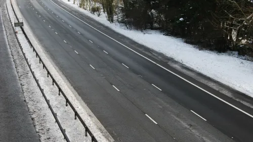 Photo of an empty three-lane highway in winter.