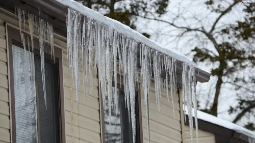 Icicles form from the roof of an apartment during freezing conditions