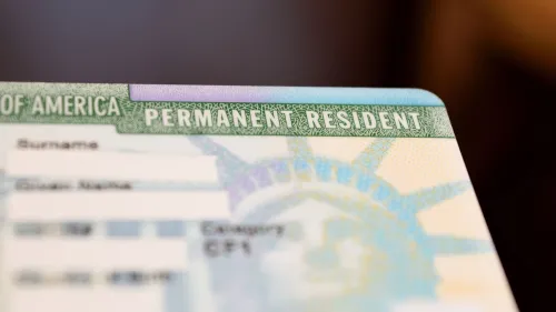 A permanent residency card with the names blurred for confidentiality.