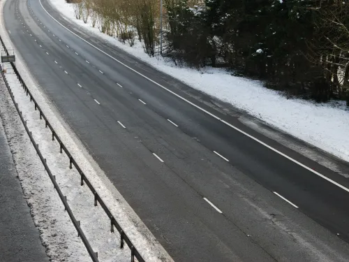 Photo of an empty three-lane highway in winter.