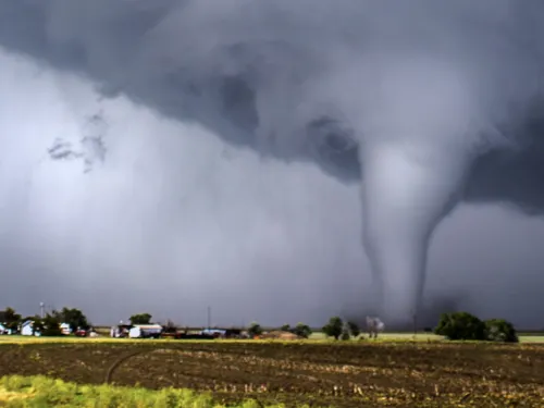 Tornado moving across a country landscape