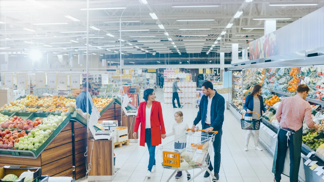 Photo of people shopping for food in a supermarket.