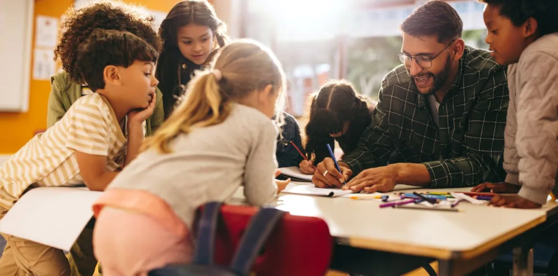 Students engaging in an after-school program with an adult leading the activity